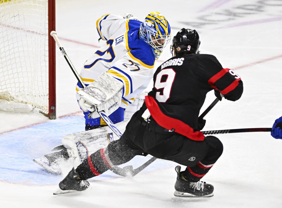 Buffalo Sabres goaltender Devon Levi (27) makes a save against Ottawa Senators center Josh Norris (9) during third-period NHL hockey game action in Ottawa, Ontario, Sunday, Dec. 31, 2023. (Justin Tang/The Canadian Press via AP)