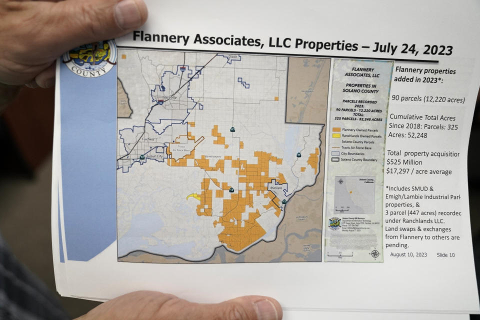 Mayor Ron Kott holds a map showing land acquisitions by Flannery Associates at City Hall in Rio Vista, Calif., Wednesday, Aug. 30, 2023. Silicon Valley billionaires and investors are behind a years-long, secretive land buying spree of more than 78 square miles (202 square kilometers) of farmland in Solano County with the goal of creating a new city. (AP Photo/Godofredo A. Vásquez)