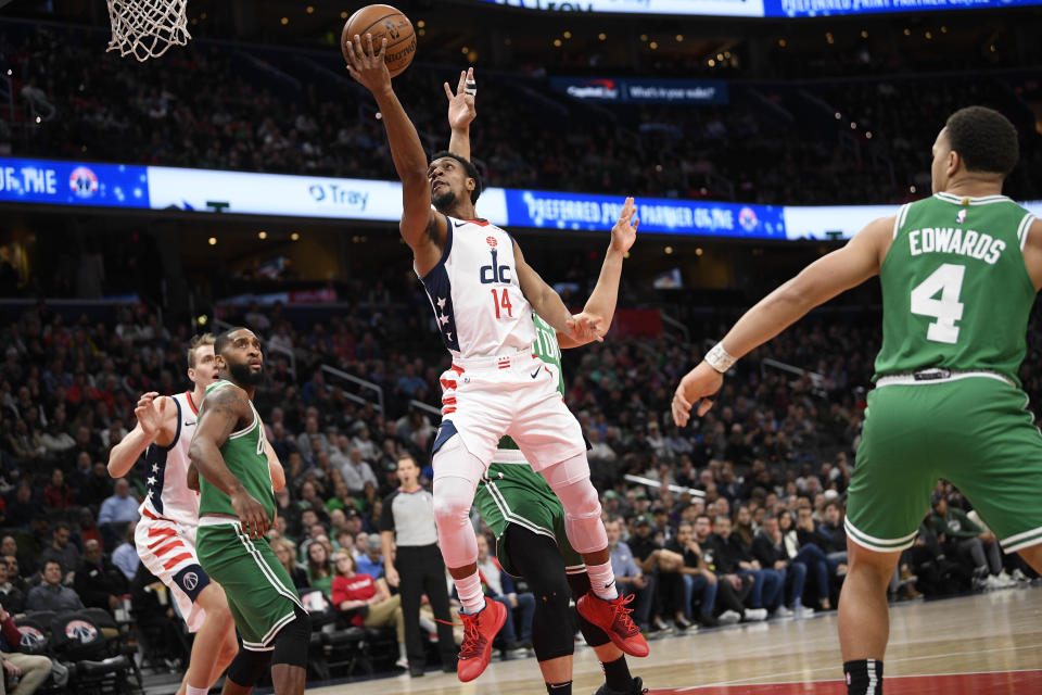 Washington Wizards guard Ish Smith (14) goes to the basket past Boston Celtics guard Carsen Edwards (4) during the first half of an NBA basketball game, Monday, Jan. 6, 2020, in Washington. The Wizards won 99-94. (AP Photo/Nick Wass)