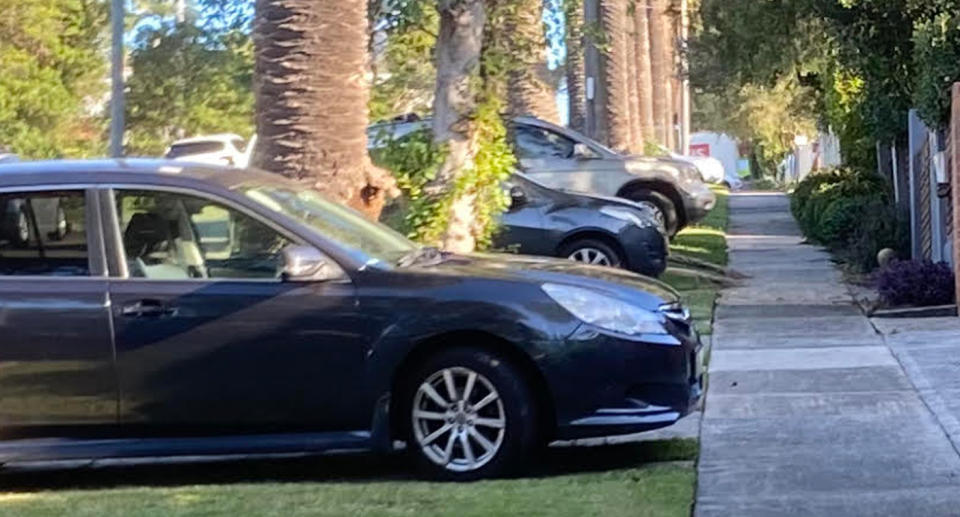 Cars parked on driveways on Sydney street.