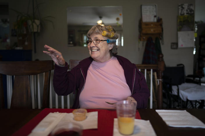 Betty Bednarowski waves at the table during breakfast, Tuesday, Nov. 30, 2021, in Rotterdam Junction, N.Y. (AP Photo/Wong Maye-E)