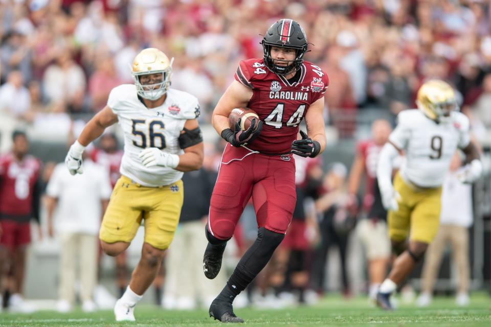 Dec 30, 2022;  Jacksonville, FL, USA;  South Carolina Gamecocks tight end Nate Adkins (44) runs after the catch against the Notre Dame Fighting Irish in the first quarter in the 2022 Gator Bowl at TIAA Bank Field.  Mandatory Credit: Jeremy Reper-USA TODAY Sports