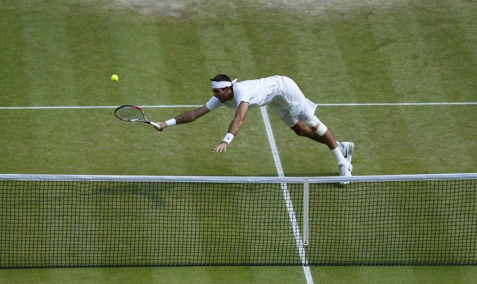 Argentina's Juan Martin Del Potro dives for the ball in his match against Serbia's Novak Djokovic during day eleven of the Wimbledon Championships at The All England Lawn Tennis and Croquet Club, Wimbledon.