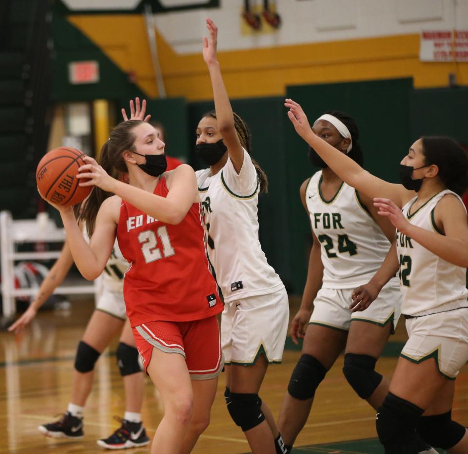 Red Hook's Emilie Kent is swarmed by Roosevelt defenders in the paint during a Jan. 26, 2022 girls basketball game.