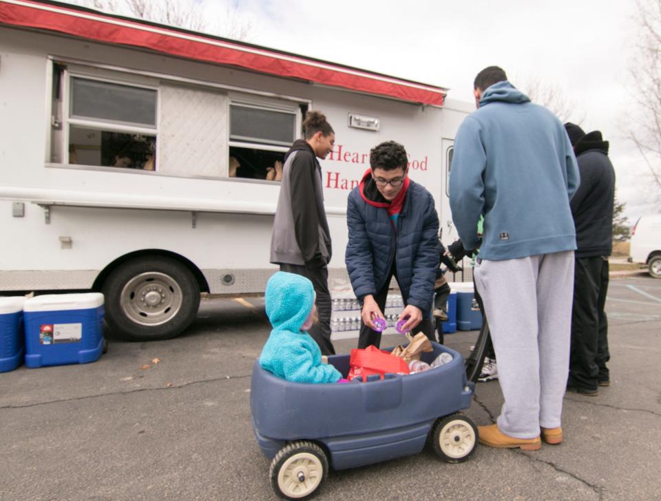 Danté Morris puts items donated by the Salvation Army into a wagon holding Jasmine Morris, two-years-old at the time, for their family of eight Tuesday, March 17, 2020.