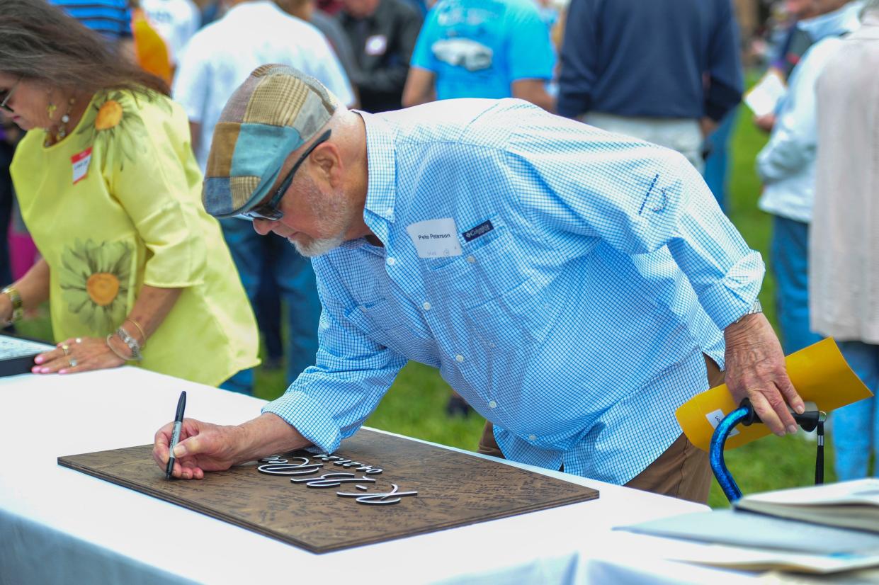 Pete Peterson signs the K-25 reunion plaque during the K-25 first annual reunion on Saturday, April 27, 2024 in Oak Ridge, Tenn.