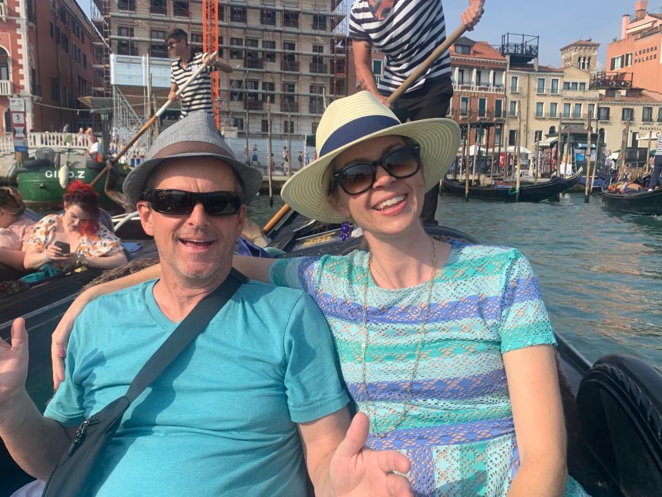 The author and her husband wearing hats sitting on a gondola