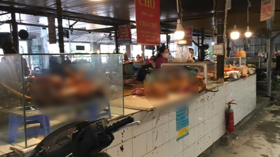 Inside a wet market in Vietnam selling dog. Images of the dogs have been blurred. 