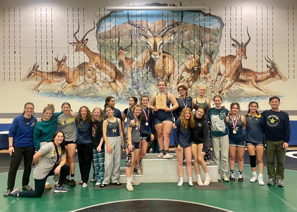 The PSD girls wrestling team poses for a team photo after taking second place at the program's first-ever standalone tournament on Dec. 9, 2023, at Poudre High School in Fort Collins.