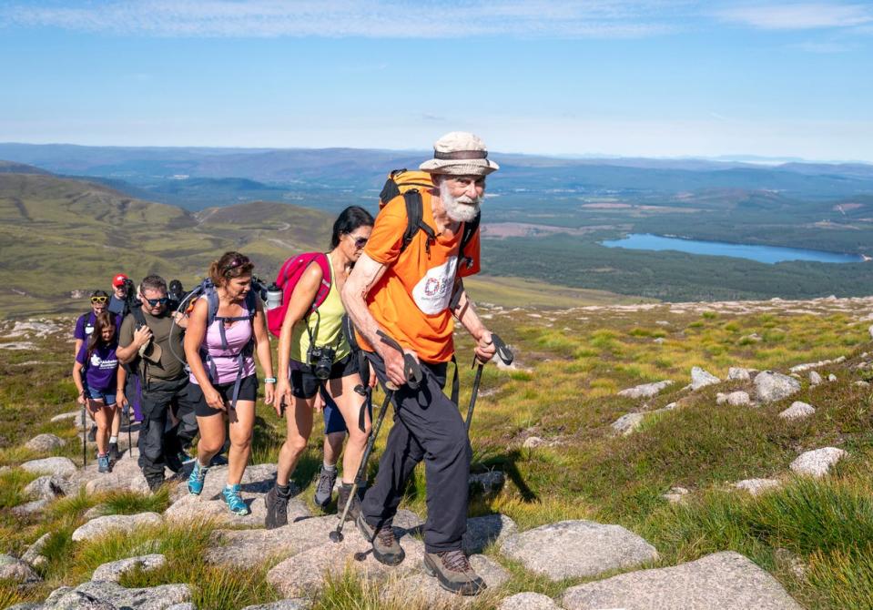 Nick Gardner, aged 82, climbs his final mountain the Cairn Gorm, with family, supporters and fellow walkers, after setting the goal of climbing all 282 Munros in 1200 days following his wife Janet being taken into care with Alzheimer’s and osteoporosis. Picture date: Saturday August 13, 2022. PA Photo. See PA story CHARITY Munro. Photo credit should read: Jane Barlow/PA Wire