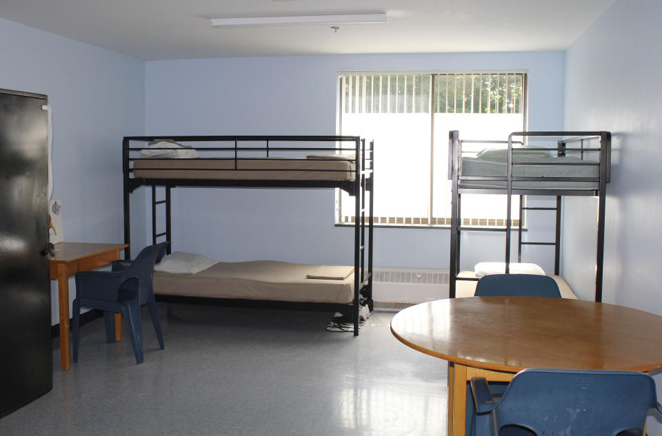 In this Aug. 5, 2019 photo, bunk beds line the wall of a dormitory-style room at the Hampden County Sheriff's Department's minimum security, residential treatment facility in Springfield, Mass. The county jail is marking one year of treating men civilly committed for substance abuse reasons. Sheriff Thomas Cocchi and his supporters have said the program, one of just three in the state treating civilly committed men and the only in western Massachusetts, can play a key role in efforts to curb the Springfield area's opioid problem. But civil rights group want the practice of imprisoning men for addiction treatment ended. (AP Photo/Philip Marcelo)