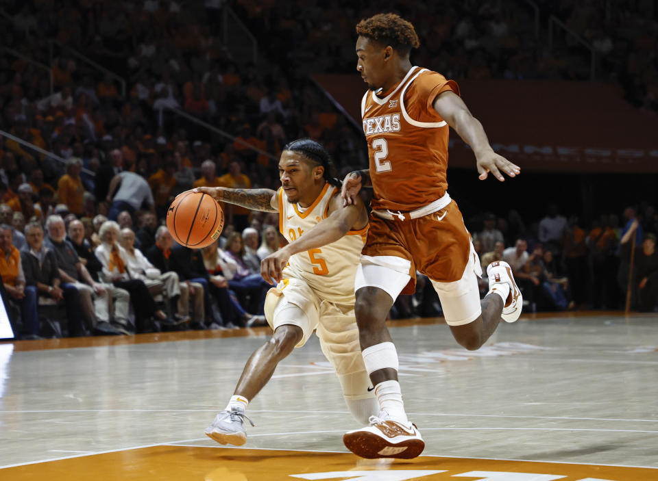 Tennessee guard Zakai Zeigler (5) drives against Texas guard Arterio Morris (2) during the first half of an NCAA college basketball game Saturday, Jan. 28, 2023, in Knoxville, Tenn. (AP Photo/Wade Payne)