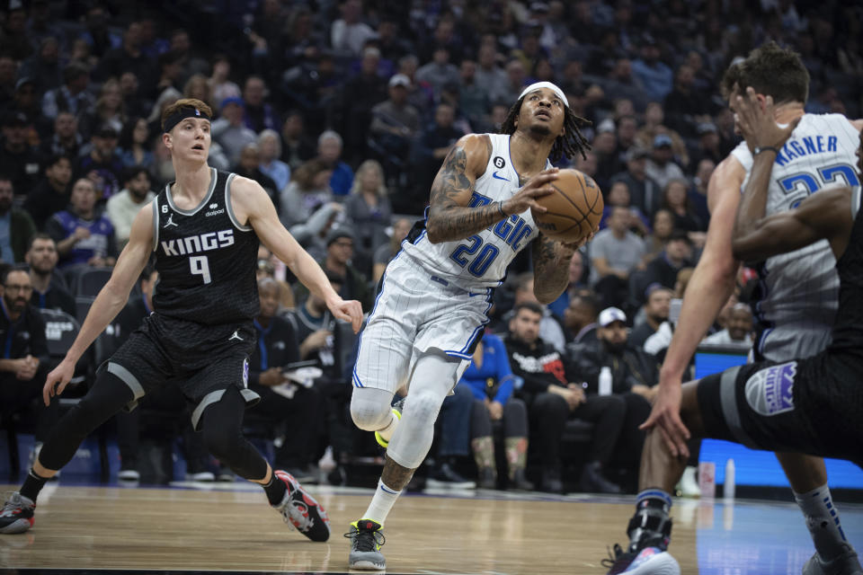 Orlando Magic guard Markelle Fultz (20) passes Sacramento Kings guard Kevin Huerter (9) as he goes to the basket in the first quarter in an NBA basketball game in Sacramento, Calif., Monday, Jan. 9, 2023. (AP Photo/José Luis Villegas)