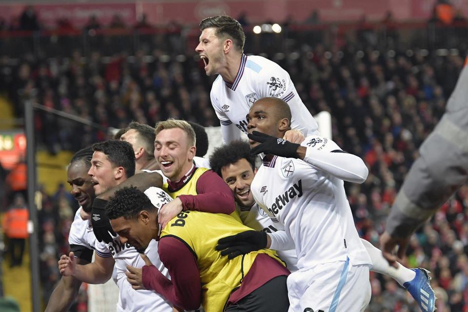 In the thick of it: Bowen (centre, in bib) celebrates with his team-mates after Pablo Fornals’ goal at Anfield on Monday (West Ham United FC via Getty Ima)