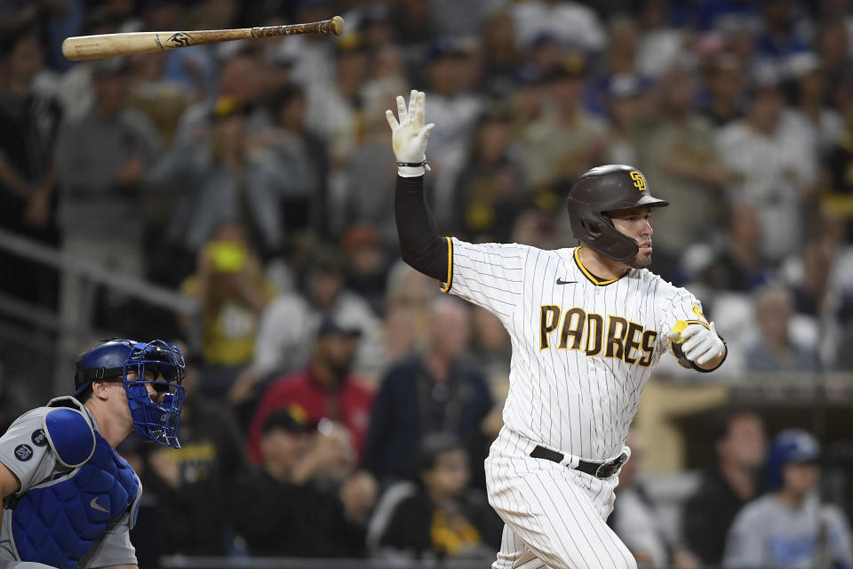 San Diego Padres' Victor Caratini (17) tosses his bat after hitting a sacrifice fly ball during the eighth inning of a baseball game against the Los Angeles Dodgers, Wednesday, June 23, 2021, in San Diego. (AP Photo/Denis Poroy)