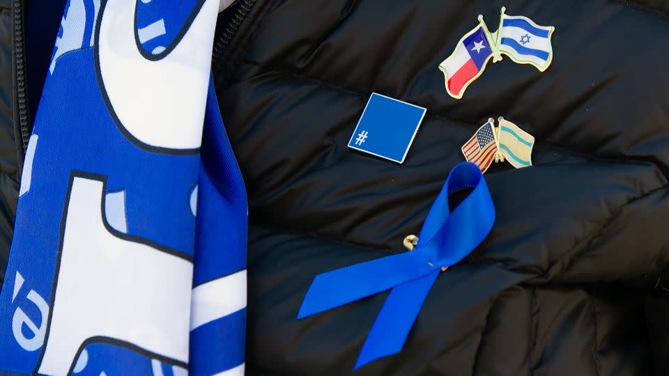 A woman from Dallas shows off her pro-Israeli pins before attending Tuesday's rally in DC. - Rebecca Wright/CNN