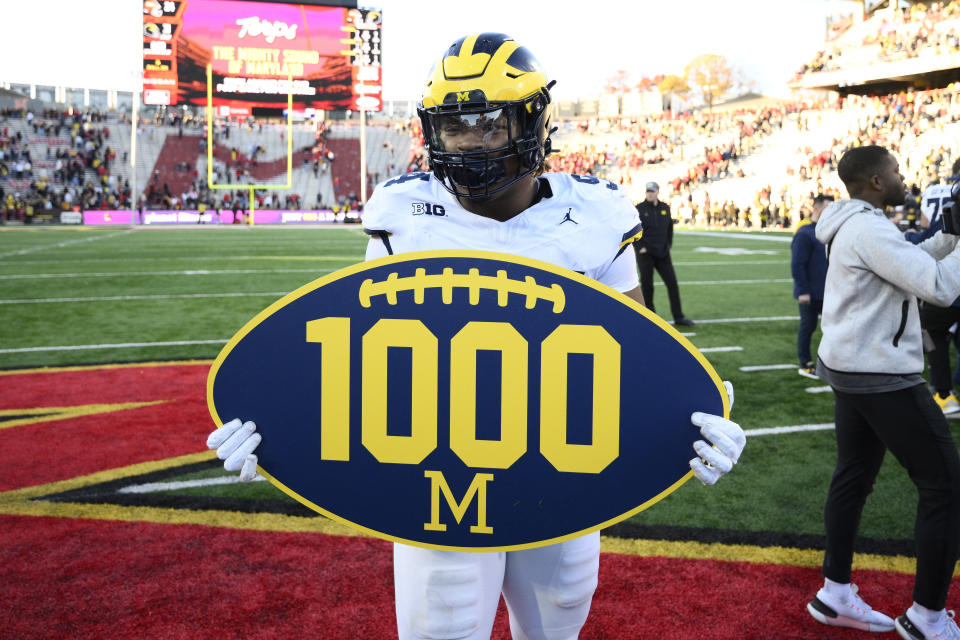 Michigan defensive lineman Kris Jenkins (94) holds up a 1,000 sign after an NCAA college football game against Maryland, Saturday, Nov. 18, 2023, in College Park, Md. Michigan won 31-24. Michigan got their 1,000 win in school history. (AP Photo/Nick Wass)