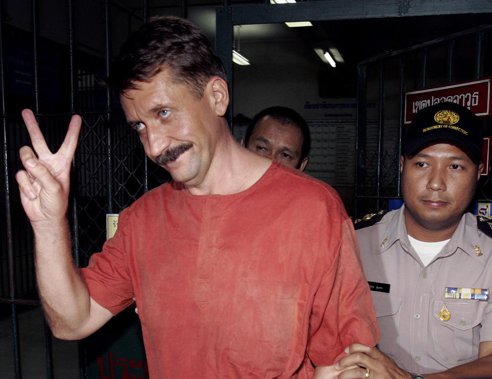 FILE - Alleged Russian arms dealer Viktor Bout gestures as he is taken to a van to be transported back to prison at a criminal court in Bangkok, Thailand on Aug. 11, 2009. Russia has freed WNBA star Brittney Griner on Thursday in a dramatic high-level prisoner exchange, with the U.S. releasing notorious Russian arms dealer Viktor Bout. (AP Photo/Apichart Weerawong, File)