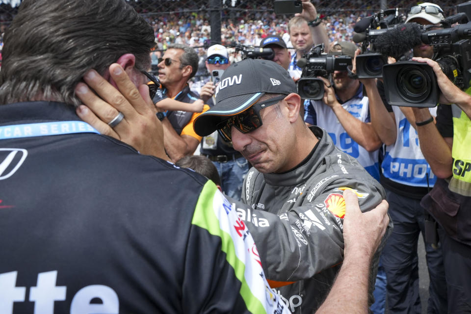 Tony Kanaan, of Brazil, greets a crew-member before the Indianapolis 500 auto race at Indianapolis Motor Speedway in Indianapolis, Sunday, May 28, 2023. (AP Photo/AJ Mast)