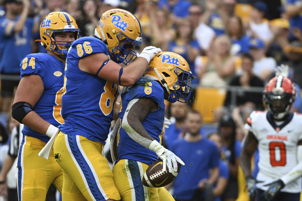 Pittsburgh running back Rodney Hammond Jr. (6) celebrates with tight end Gavin Bartholomew (86) after scoring a touchdown during the first half of an NCAA college football game against Syracuse, Saturday, Nov. 5, 2022, in Pittsburgh. (AP Photo/Barry Reeger)