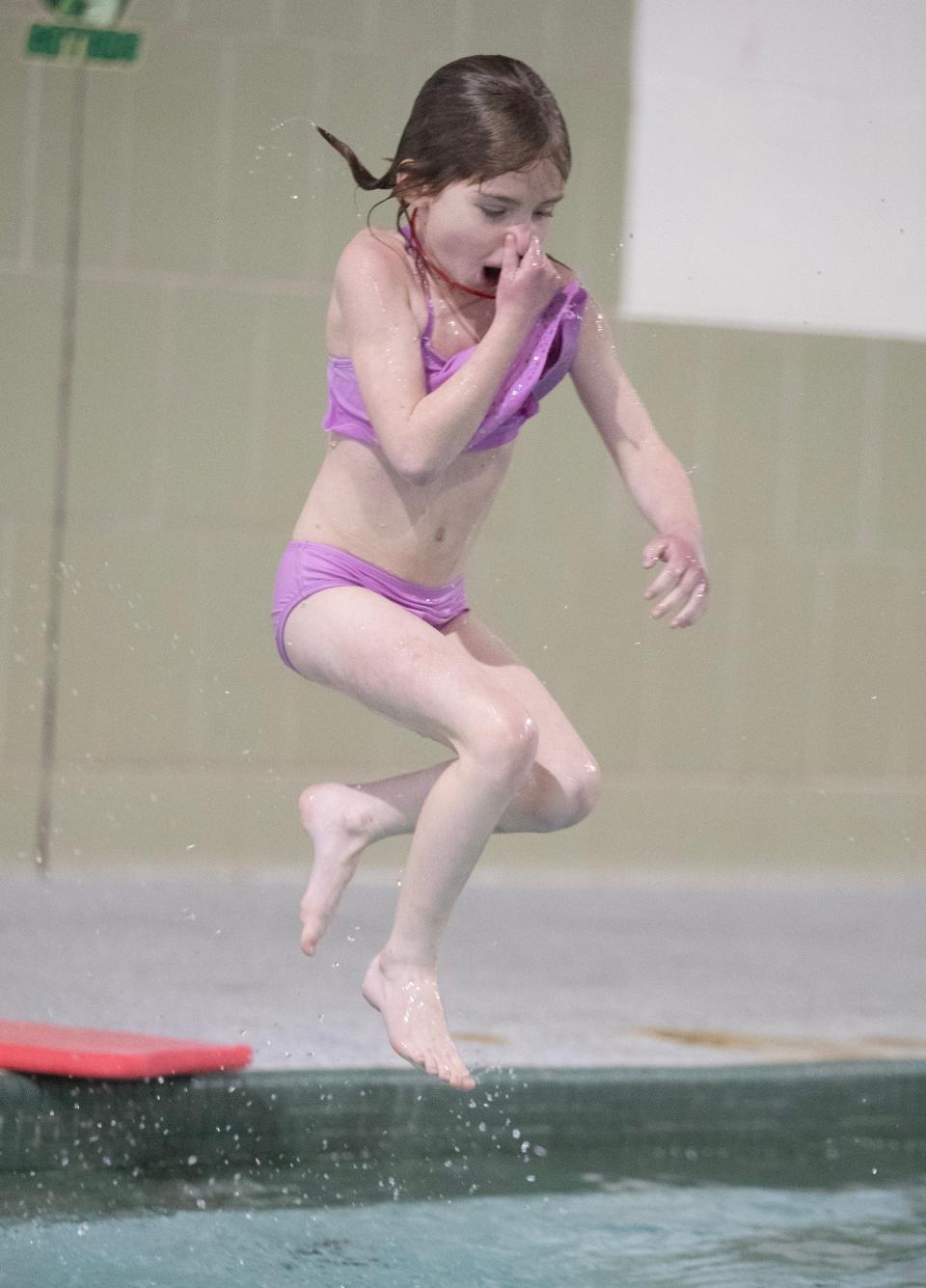 Jocilyn Wise, 8, jumps into the shallow end during pool time at the Massillon YMCA School Day Off Kid Care program.