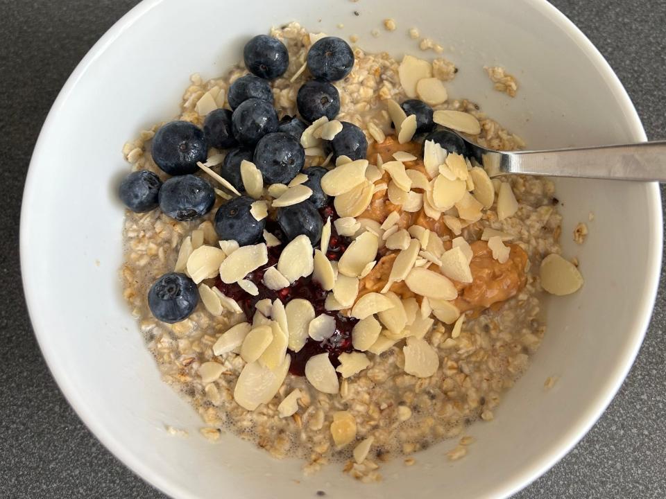 Oatmeal with blueberries, peanut butter, and almond flakes.