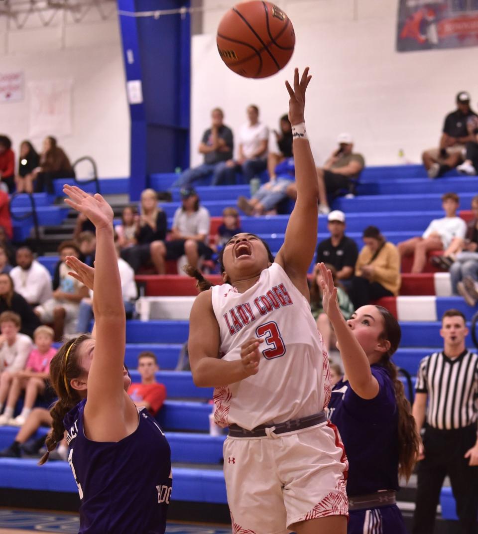 Cooper's Alliyah Ralston (3) drives to the basket against the Merkel defense. Merkel beat the Lady Cougars 47-44 in the non-district game Tuesday at Cougar Gym.