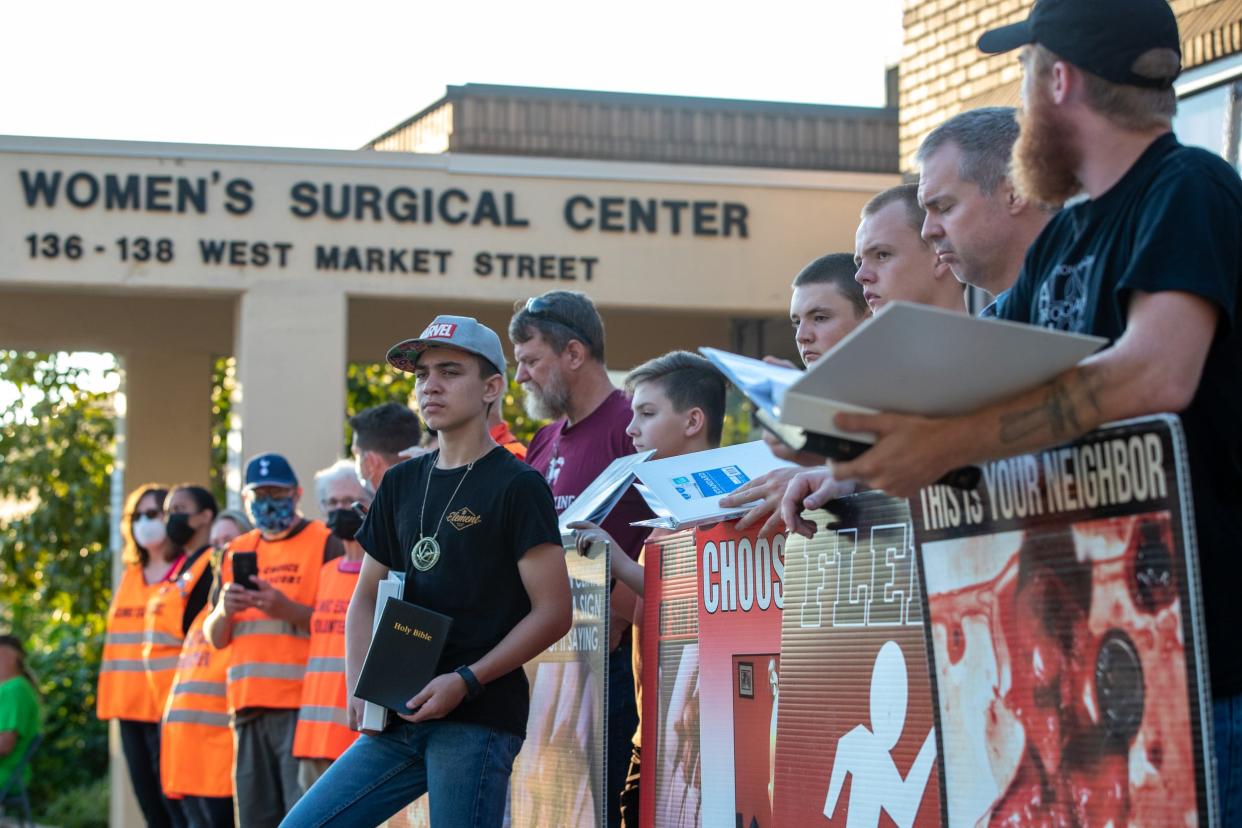 Protesters and clinic escorts fill the sidewalk area outside the EMW Women's Surgical Center facility on West Market Street in Louisville on Sept. 18, 2021.