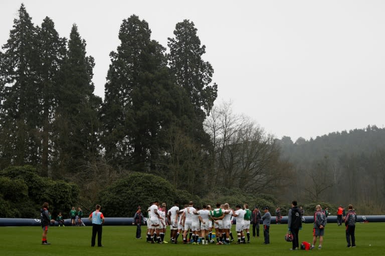 England's head coach Eddie Jones (4R) takes a team training session at Pennyhill Park in Bagshot, west of London on March 16, 2017