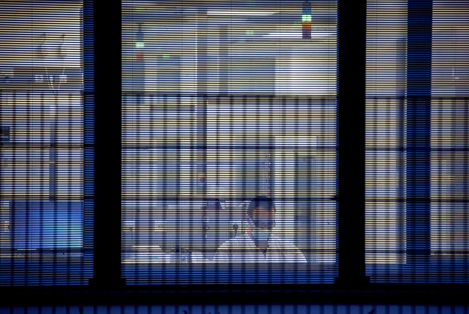 File -- In this Tuesday, Nov.10, 2020 file photo a laboratorian works behind jalousies at the headquarters of the German biotechnology company "BioNTech" in Mainz, Germany. Germany prepares for the vaccination of the German population during the upcoming month. (AP Photo/Michael Probst, file)