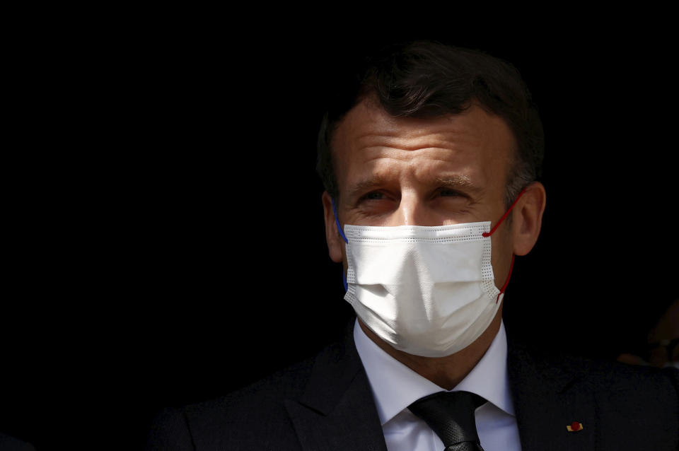 French President Emmanuel Macron visits a child psychiatry department at Reims hospital, eastern France, to discuss the psychological impact of the COVID-19 crisis and the lockdown on children and teenagers in France, Wednesday, April 14, 2021. (Christian Hartmann/Pool via AP)