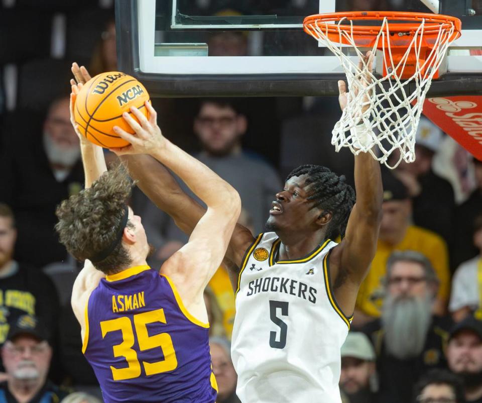 Wichita State’s Isaac Abidde defends Lipscomb’s Grant Asman during the first half of their season opener on Monday night at Koch Arena. Travis Heying/The Wichita Eagle