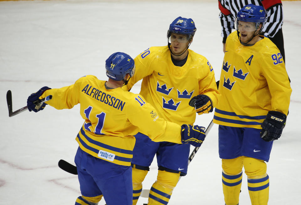 Sweden forward Alexander Steen, center, celebrates his first period goal against Slovenia with forward Daniel Alfredsson, left, and forward Gabriel Landeskog during a men's quarterfinal ice hockey game at the 2014 Winter Olympics, Wednesday, Feb. 19, 2014, in Sochi, Russia. (AP Photo/Mark Humphrey)