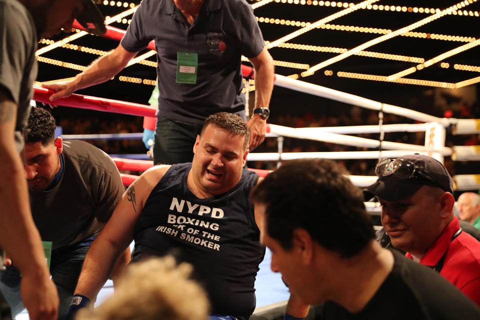 <p>Chris D’Antonio is helped out of the ring after injuring his knee in the ring during the NYPD Boxing Championships at the Theater at Madison Square Garden on June 8, 2017. (Photo: Gordon Donovan/Yahoo News) </p>