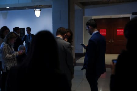 Reporters wait outside of closed U.S. House Intelligence Committee rooms while Intelligence Community Inspector General Atkinson attends a closed briefing on the handling of a reported whistleblower complaint against the Trump White House, on Capitol Hill