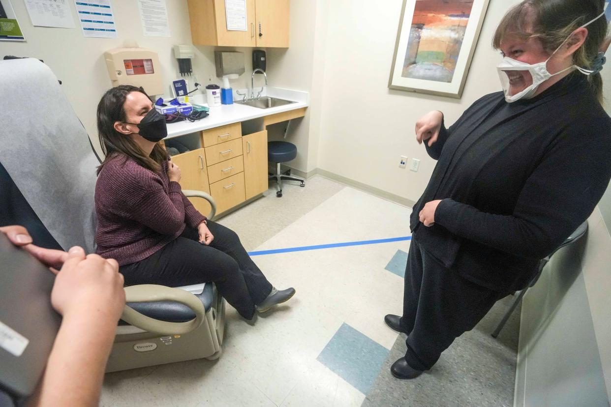 Dr. Jackson Nguyen enters the room while Jenny Buechner, volunteer, left, and Morgan Inches, right, sign with one another Friday, Feb. 24, 2023, at Ascension Columbia St., Mary's Milwaukee - Prospect Medical Commons located at 2311 N. Prospect Ave., Milwaukee.