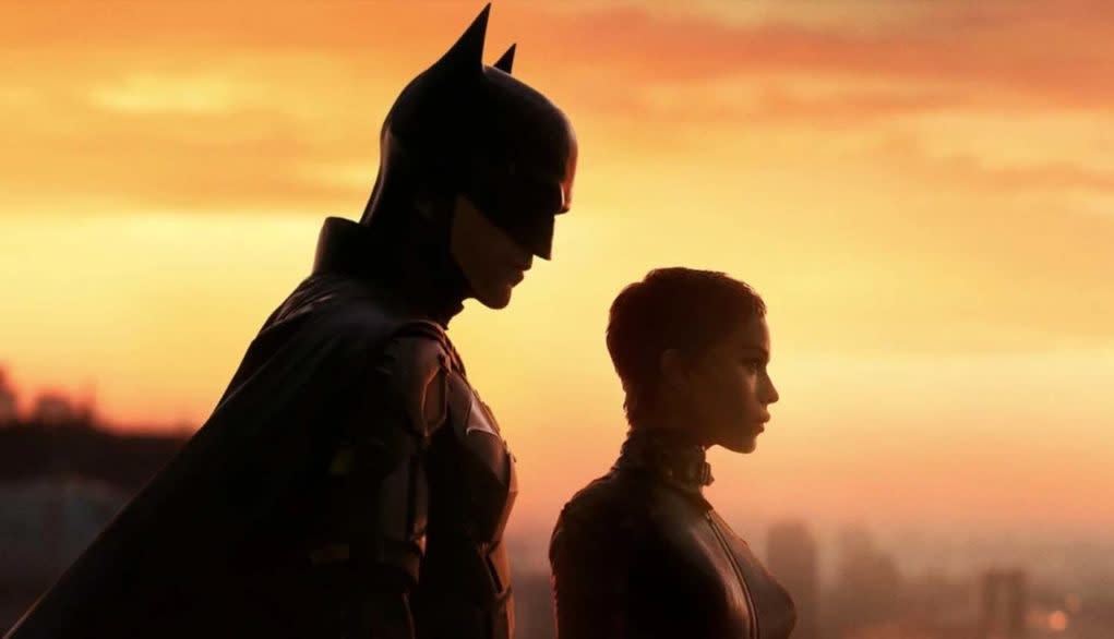  Robert Pattinson's Dark Knight and Zoe Kravtiz's Selina Kyle silhouetted against a sunset in The Batman, one of the best Batman movies. 