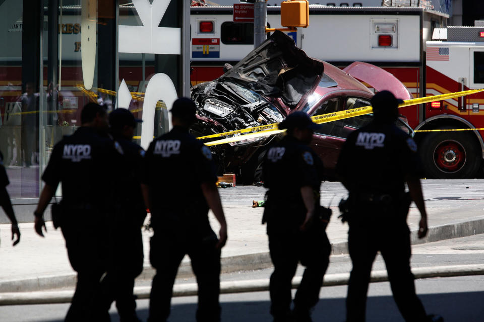 <p>Flames and smoke rises from a wrecked vehicle after it plowed into pedestrians on a busy sidewalk on the corner of West 45th St. and Broadway at Times Square, New York, NY United States on May 18, 2017. Multiple pedestrians were struck Thursday by a speeding vehicle in the heart of New York City, according to reports. (Photo: Volkan Furuncu/Anadolu Agency/Getty Images) </p>