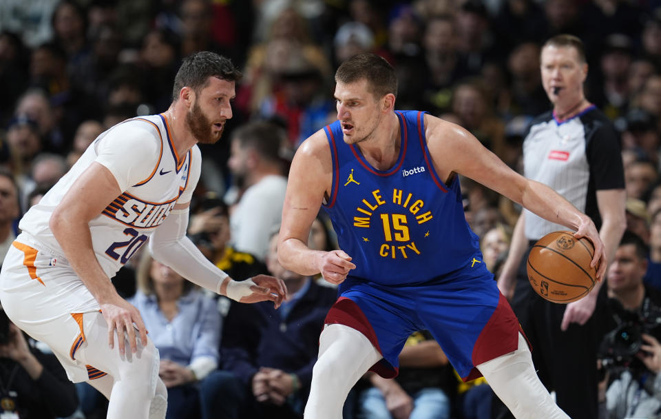 Denver Nuggets center Nikola Jokic, right, is defended by Phoenix Suns center Jusuf Nurkic during the first half of an NBA basketball game Tuesday, March 5, 2024, in Denver. (AP Photo/David Zalubowski)