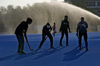 Female field hockey players of a local club attend a training session, in Karachi, Pakistan, Sunday, Nov. 13, 2022. There is only one sport that matters in Pakistan and that's cricket, a massive money-making machine. But minors sports like rugby are struggling to get off the ground due to lack of investment and interest, stunting their growth at home and chances of success overseas. Even previously popular sports like squash and field hockey, which Pakistan dominated for decades, can't find their form.(AP Photo/Fareed Khan)