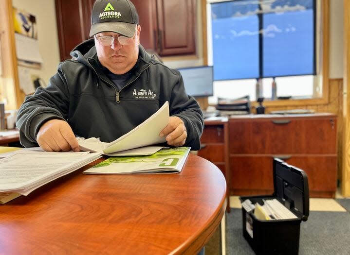 Craig Schaunaman sifts through his well-organized file of paperwork.