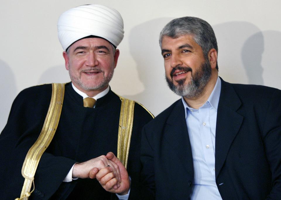 FILE - Hamas' supreme leader Khaled Mashaal and the head of Russia's Council of Muftis, Ravil Gainutdin, shake hands during their meeting in Moscow on Feb. 27, 2007. Several Hamas leaders have visited Russia, which has sought to maintain contacts with the group. (AP Photo/Misha Japaridze, File)