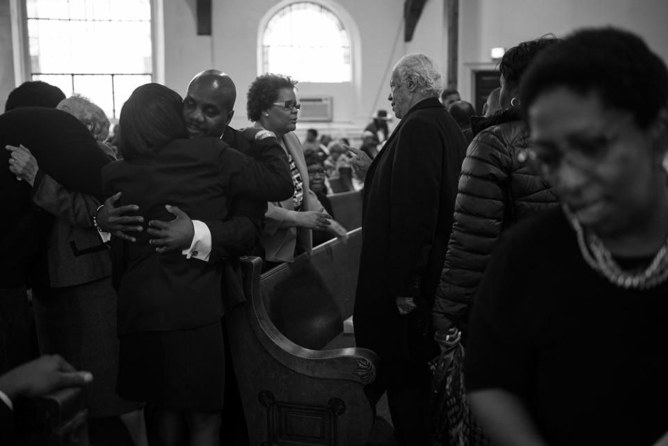 <p>Spencer Leak Sr greets a family member of the deceased at a funeral at the Union Tabernacle Missionary Baptist Church on Chicago’s south side. (Photo: Jon Lowenstein/NOOR for Yahoo News) </p>