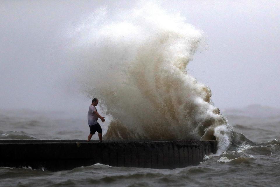 A wave crashes near Orleans Harbor in Lake Pontchartrain on Sunday as Tropical Storm Cristobal approaches the Louisiana coast.