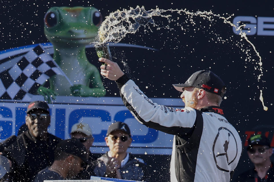 Tyler Reddick celebrates his win at a NASCAR Cup Series auto race at Talladega Superspeedway, Sunday, April 21, 2024, in Talladega. Ala. (AP Photo/Butch Dill)