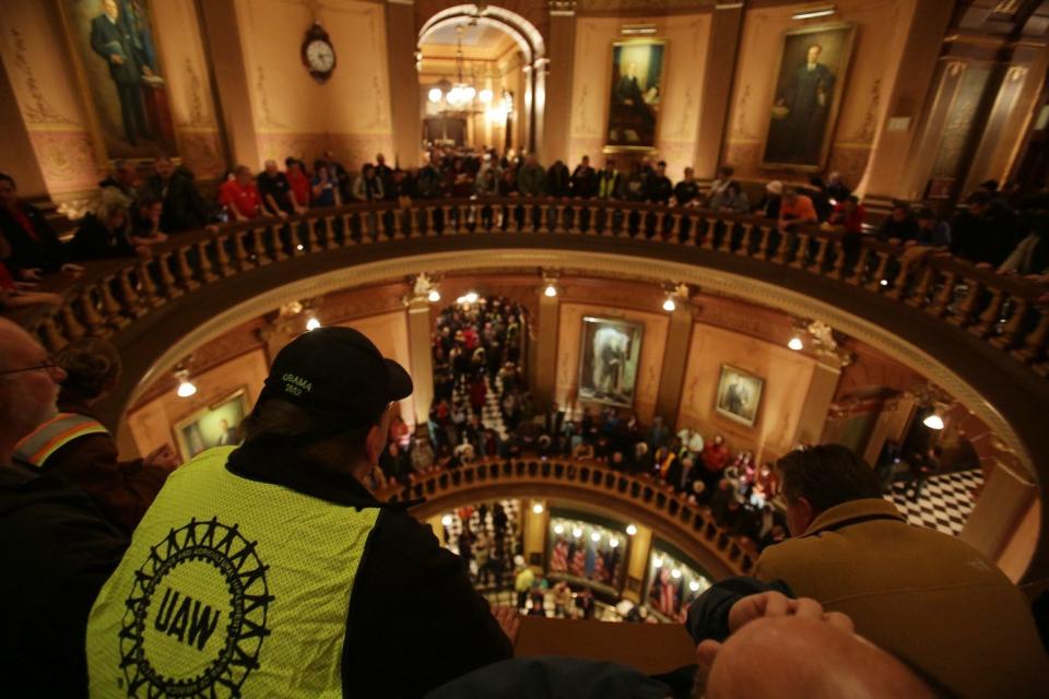 After people are finally allowed inside the Michigan State Capitol they erupt in in chant as the Michigan House votes on controversial right-to-work legislation after House Democrats walked off the chamber floor to protest the Capitol in Lansing not being opened to the public on Thursday Dec. 6, 2012.