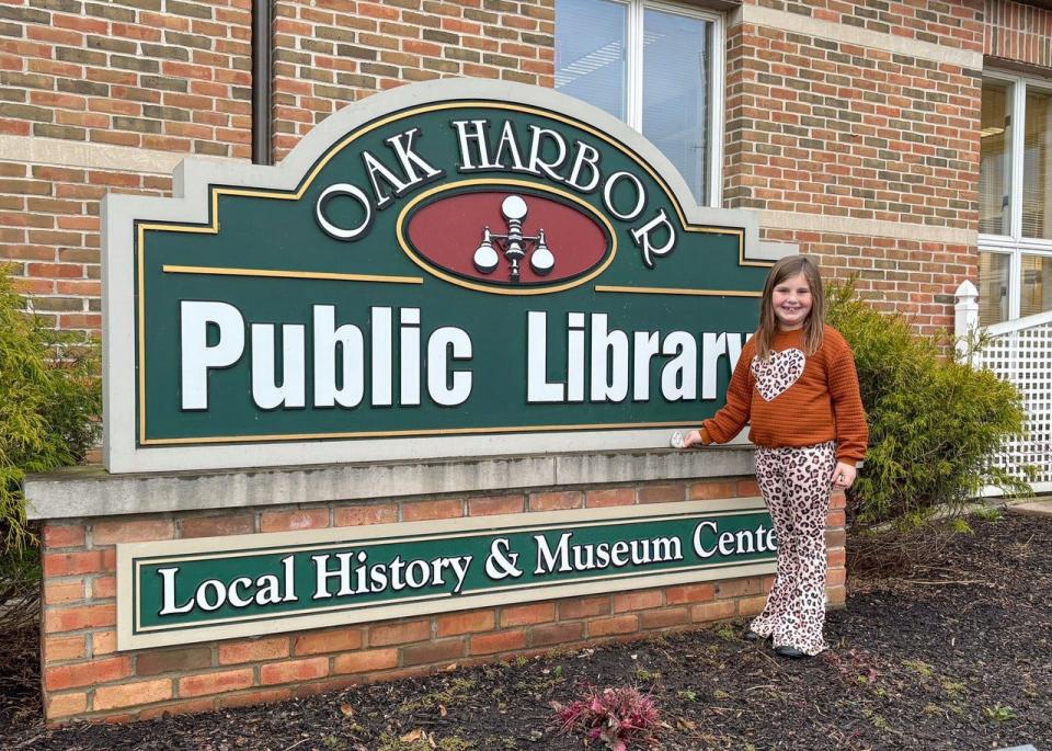 Lucy Briggs hides a rock at Oak Harbor Public Library.