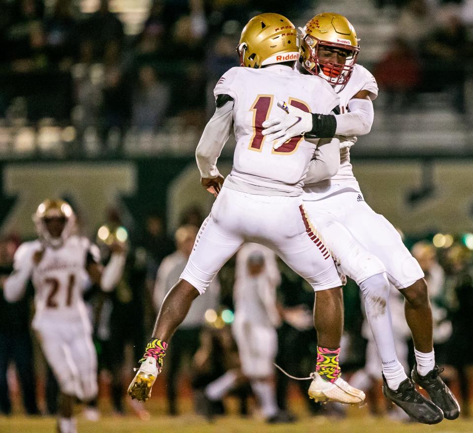 Florida State High #13 Ryan Knight, left and Florida State High #2 Ashton Hampton celebrate their win over Trinity Catholic. Trinity Catholic lost to Florida State University High School 17-12 at Trinity Catholic High School in Ocala, FL., Friday night, November 26, 2021.[Doug Engle/Ocala Star-Banner]2021