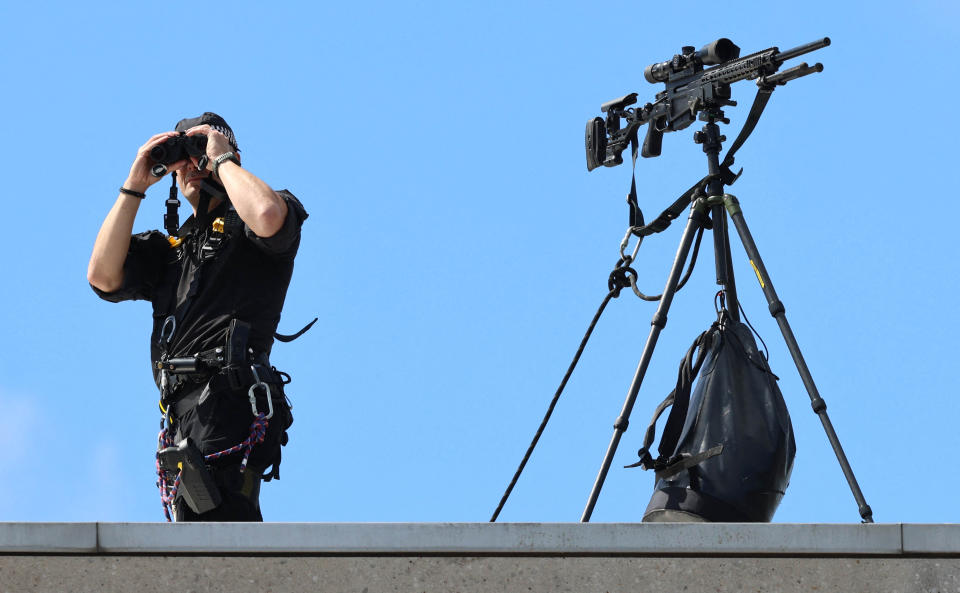 A police marksman keeps watch on the roof of the Scottish Parliament in Edinburgh on July 5, 2023 ahead of National Service of Thanksgiving and Dedication. Scotland on Wednesday will mark the Coronation of King Charles III and Queen Camilla during a National Service of Thanksgiving and Dedication where the The King will be presented with the Honours of Scotland. (Photo by Robert Perry / POOL / AFP) (Photo by ROBERT PERRY/POOL/AFP via Getty Images)