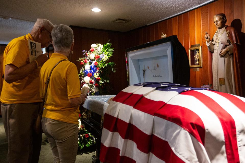U.S.S. Lexington volunteers Dominic Garofolo and Mary Reeves view U.S. Navy Capt. Robert "Bob" Batterson's body before a funeral mass at St. Pius Catholic Church on Wednesday, Aug. 30, 2023, in Corpus Christi, Texas.